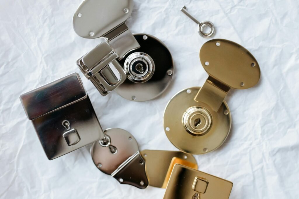 Detailed flat lay of different colored metallic locks and a key on a textured background.
